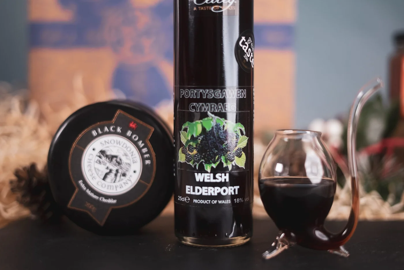 Welsh Elderport poured beside Black Bomber cheese at the winery